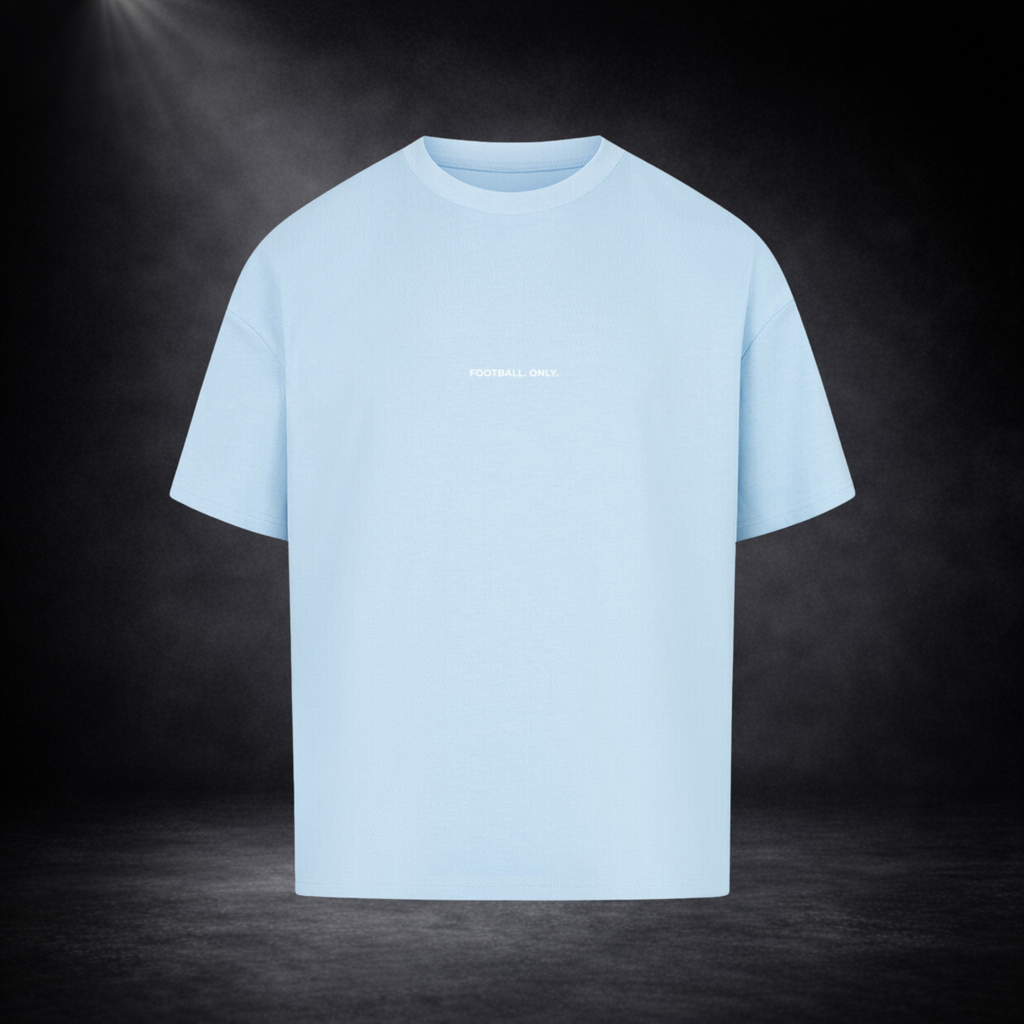 Hellblaues Oversized T-Shirt Vorderseite mit kleinem „Football Only“ Schriftzug, freigestelltes Produktbild auf dunklem Studio-Hintergrund, minimalistisches Premium Streetwear Design