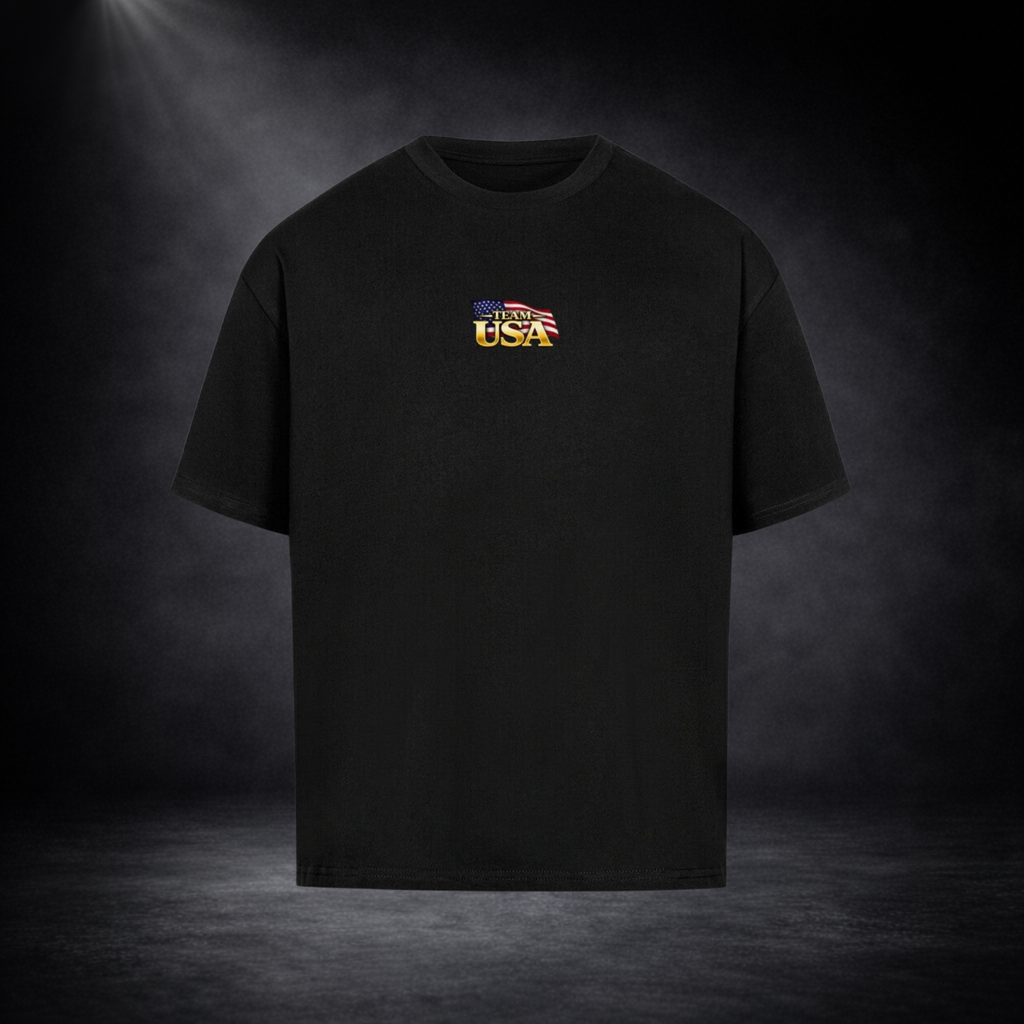Schwarzes Oversized T-Shirt mit kleinem „Team USA“-Logo auf der Brust, freigestellt vor dunklem Studio-Hintergrund